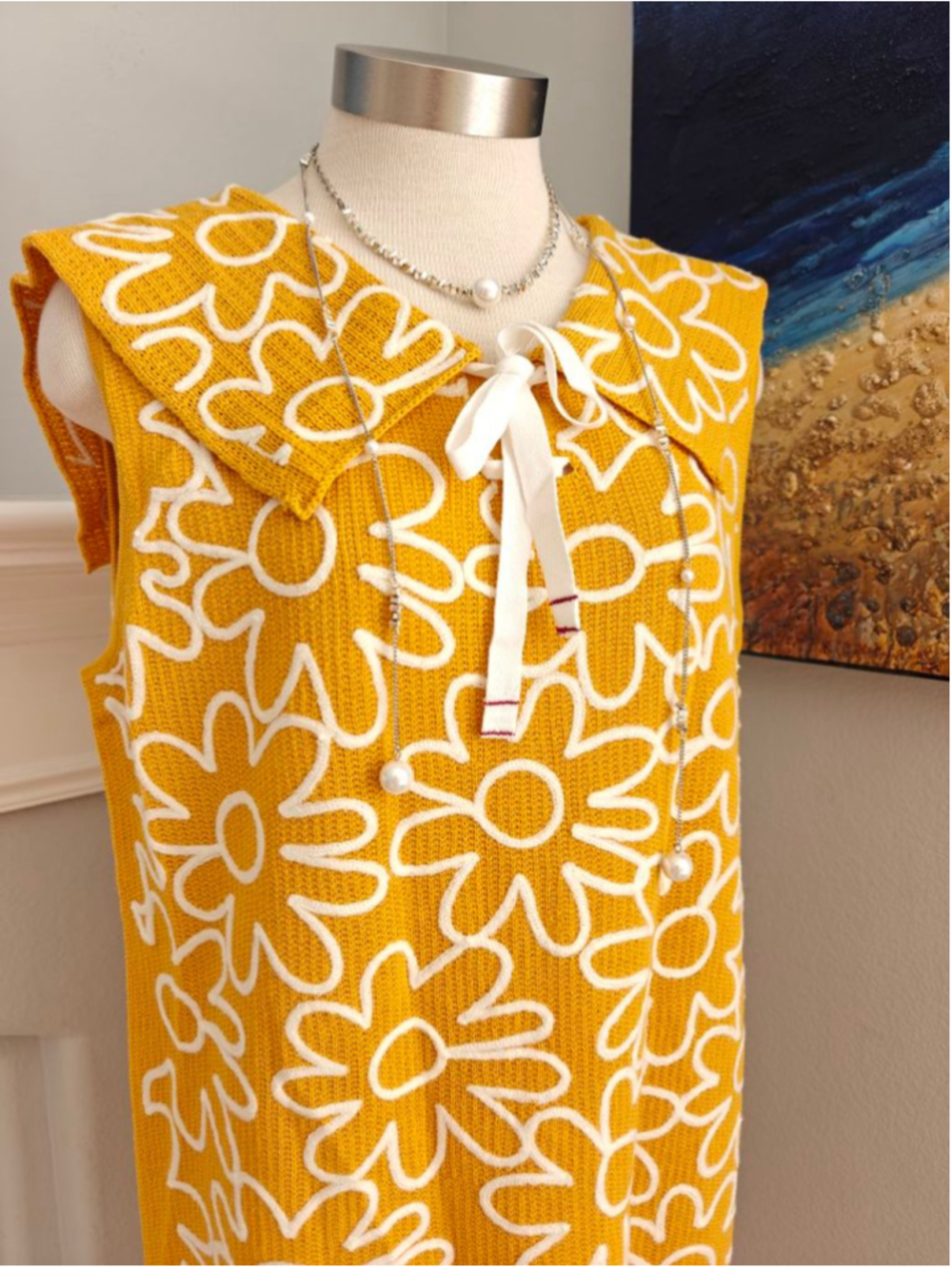 Bright mustard yellow floral knit dress with bold retro daisy patterns throughou